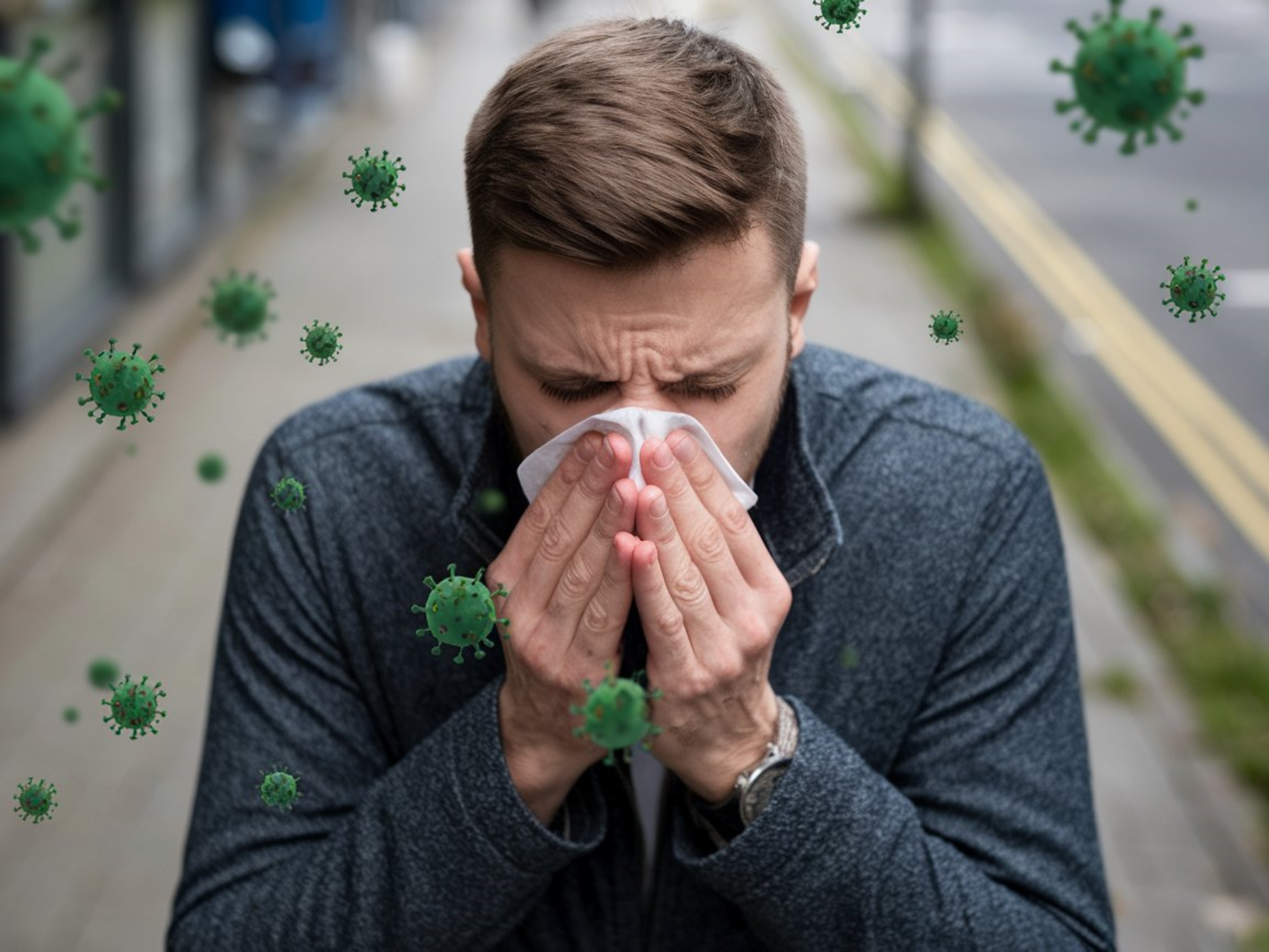 Man covering nose with tissue to protect from germs