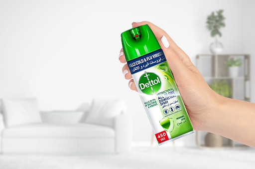 a close up shot of disinfecting spray in someone’s hand