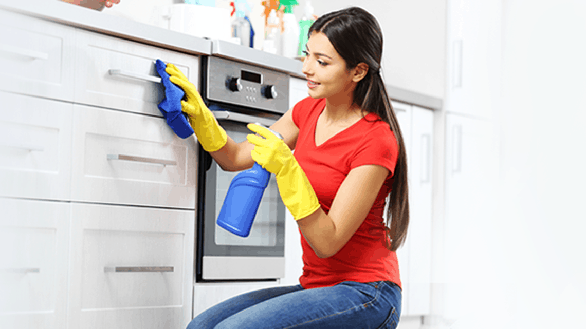 A woman cleaning the kitchen