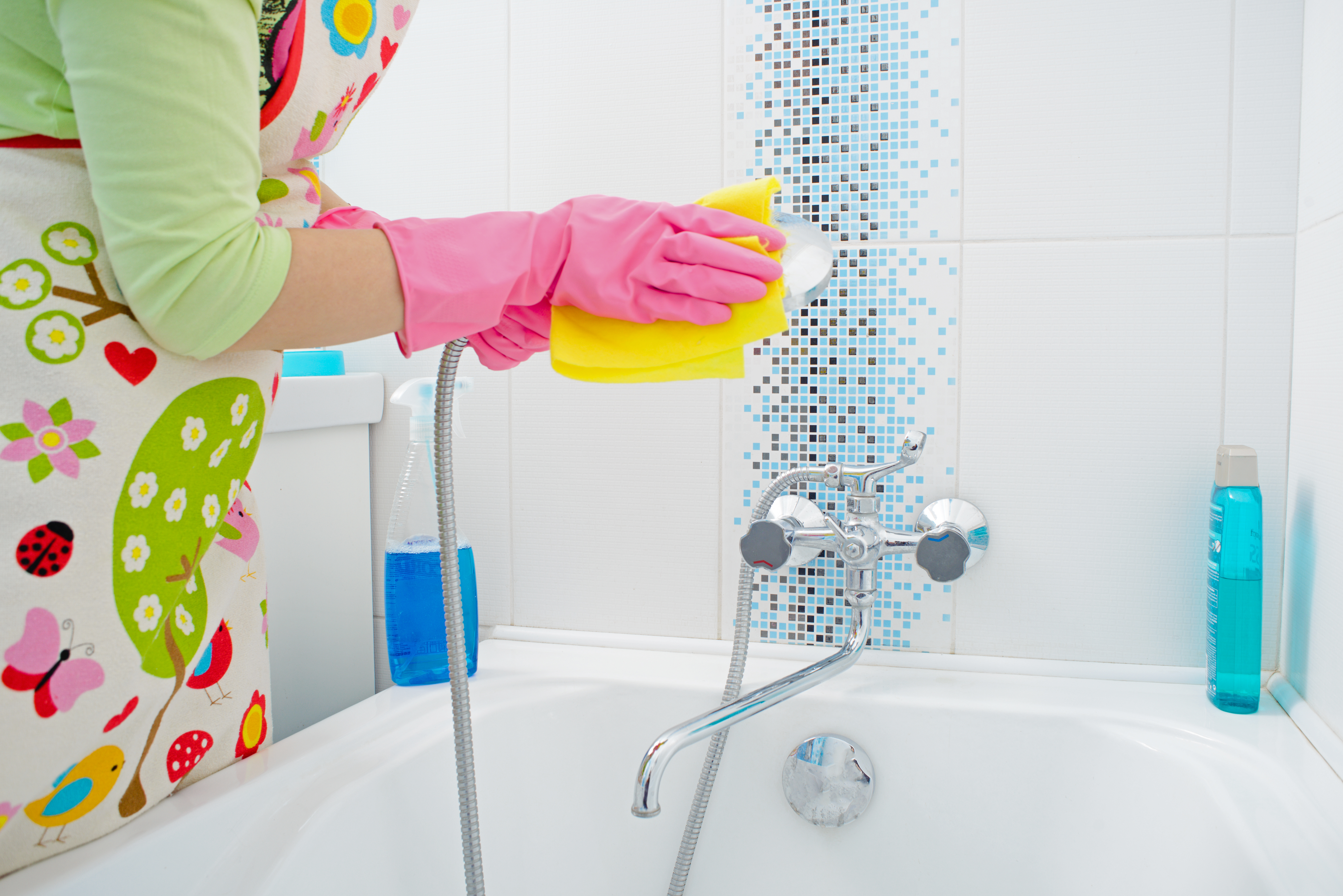 female hand with gloves cleaning shower jet